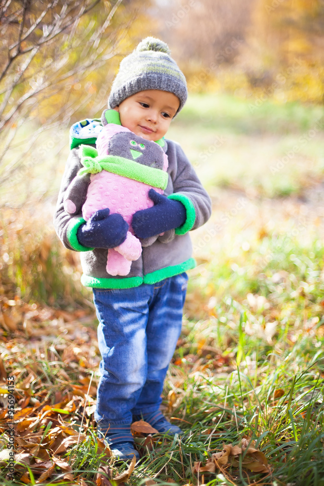 Children playing with autumn fallen leaves in park Children playing with autumn fallen leaves in park