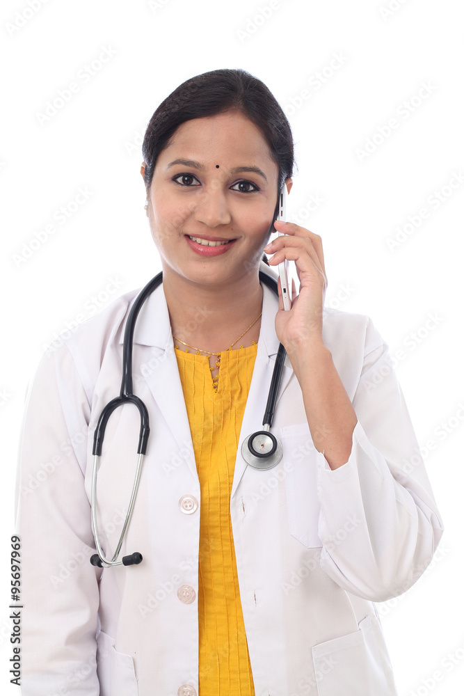 Young female doctor talking on mobile phone Young female doctor talking on mobile phone
