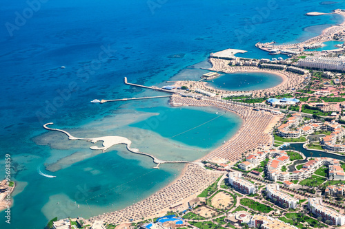 Sea bays with piers and locations enclosures for swimming and tanning, Egyptian resorts, aerial view, the Red Sea, Egypt photo