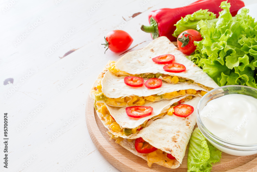 Quesadilla with sour cream, salad and tomatoes Quesadilla with sour cream, salad and tomatoes