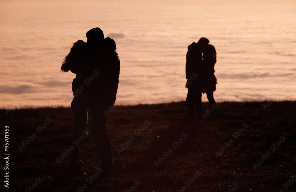 silhouetted couples kissing above inversion fog silhouetted couples kissing above inversion fog