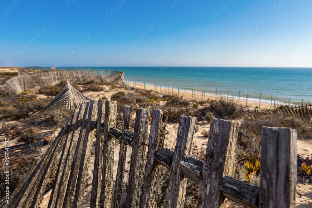 Vintage wooden fence on the background of the sea. Portugal Algarve.