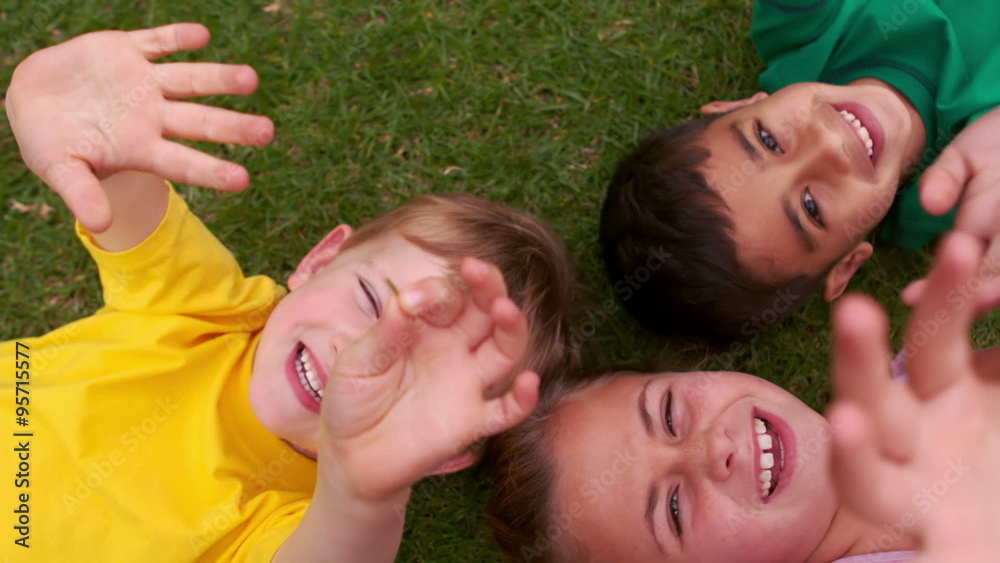 Smiling children forming a huddle in circle Smiling children forming a huddle in circle