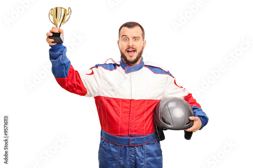 Joyful car racer holding a golden trophy