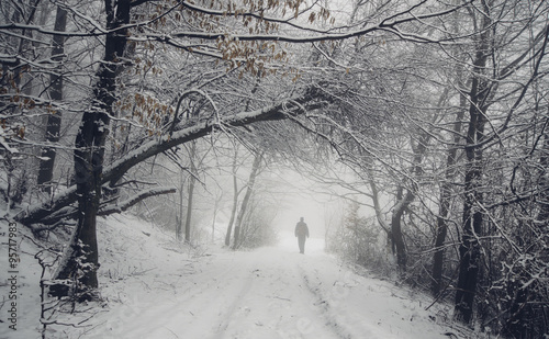 man on snowy path in winter...