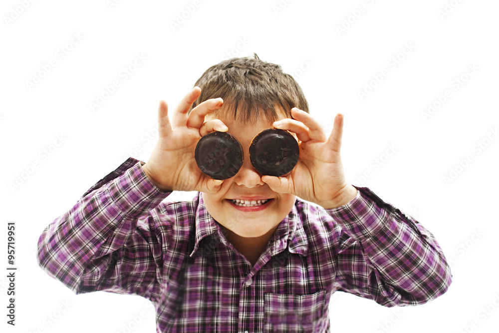 Funny image of little boy showing chocolate biscuit. Isolated on white background Funny image of little boy showing chocolate biscuit. Isolated on white background
