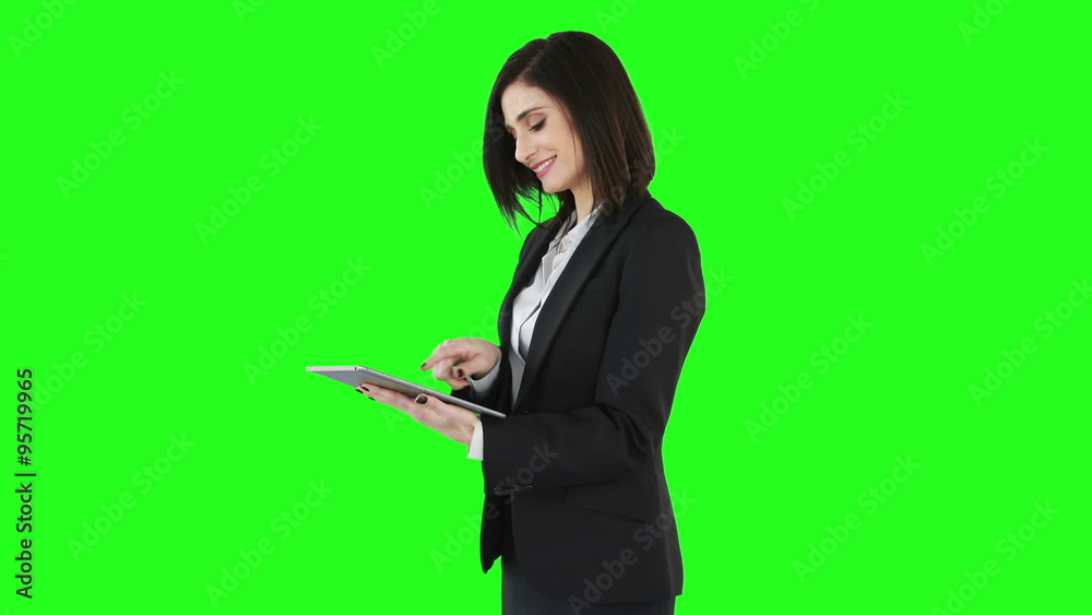 Business woman standing and using a tablet Business woman standing and using a tablet