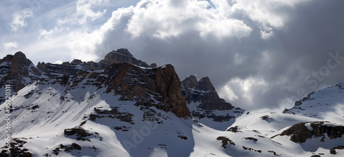 Panoramic view on winter mountains in storm clouds