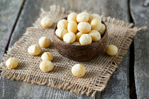 salted macadamia nuts on wooden surface photo