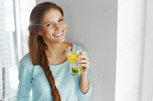 Healthy Lifestyle And Food. Woman Drinking Fruit Water. Detox.  photo