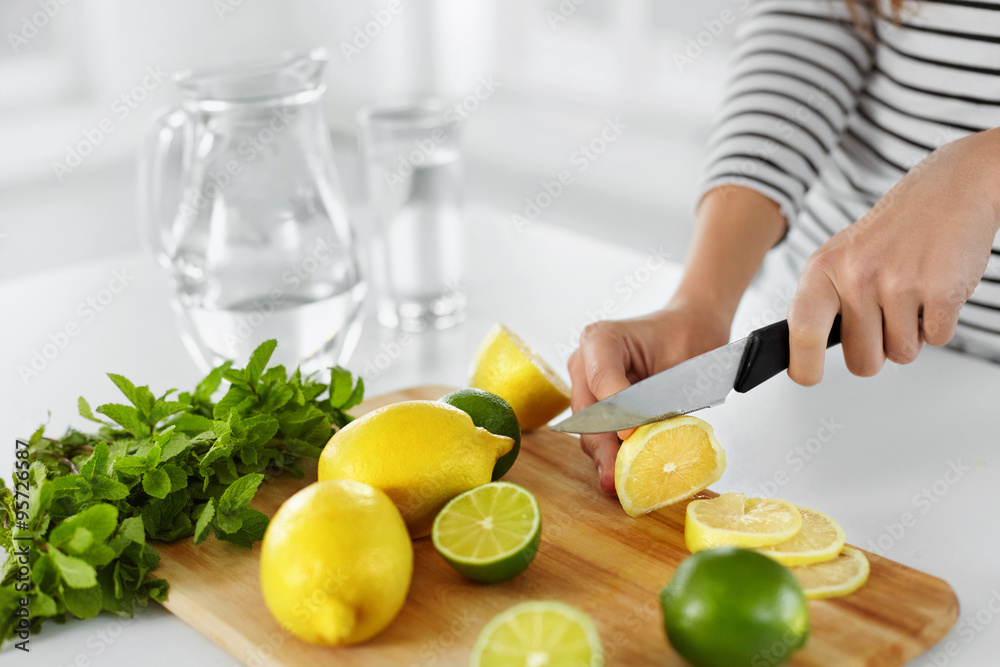 Healthy Food And Eating. Closeup Of Woman Kitchen Cutting Lemons Healthy Food And Eating. Closeup Of Woman Kitchen Cutting Lemons