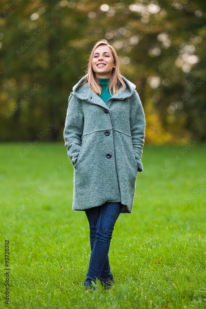 Happy woman standing in park and enjoying nature Happy woman standing in park and enjoying nature