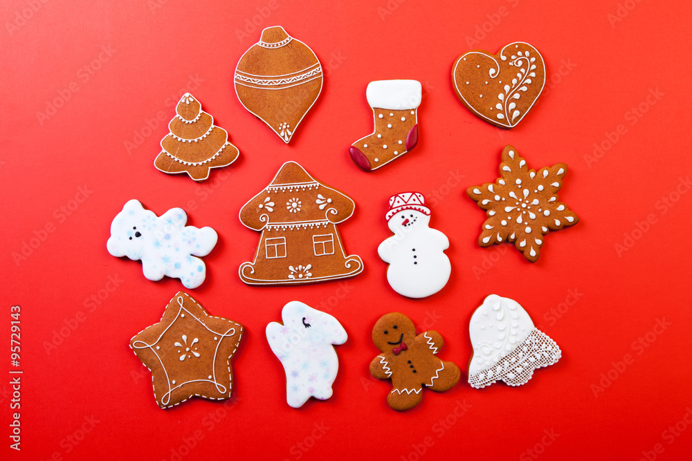 Christmas gingerbread cookies on red background.