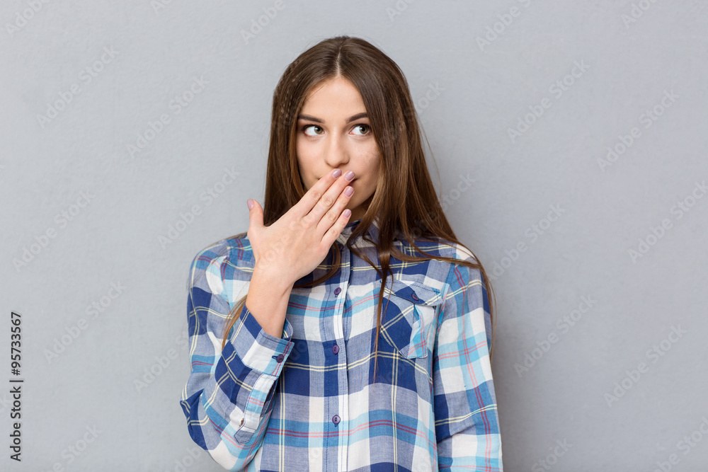 Woman covering her mouth with palm Woman covering her mouth with palm