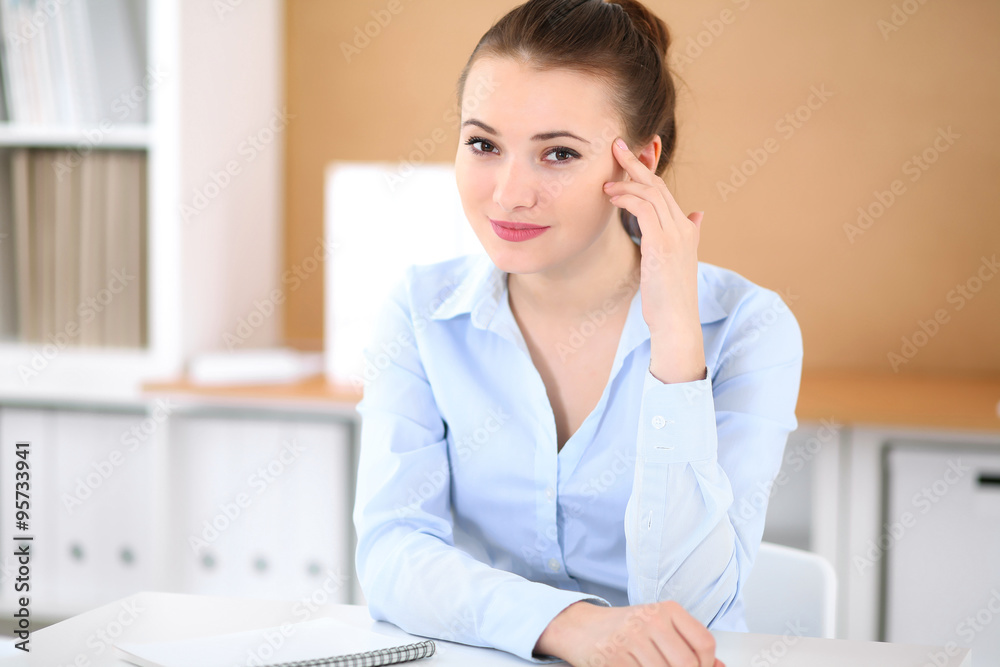 Young business woman working on laptop in office. Successful business concept. Young business woman working on laptop in office. Successful business concept.