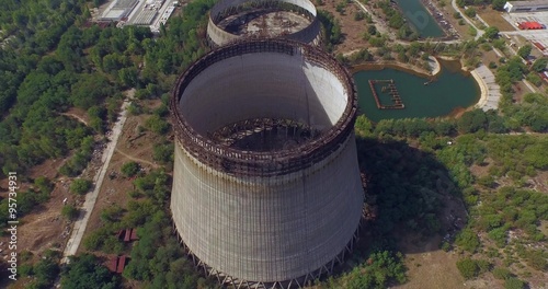 Aerial view. Cooling towers unfinished srade of the Chernobyl nuclear power plant. Flying at Chernobyl disaster zone. Ukraine.