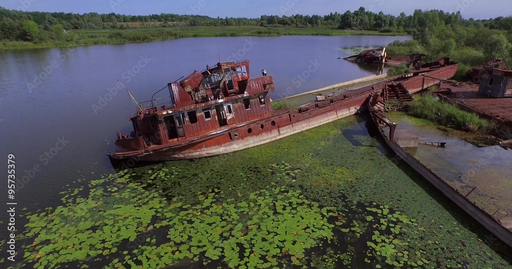 Abandoned barges and boats on the river of Pripyat near Chernobyl town. Ukraine. Aerial view. Abandoned barges and boats on the river of Pripyat near Chernobyl town. Ukraine. Aerial view.