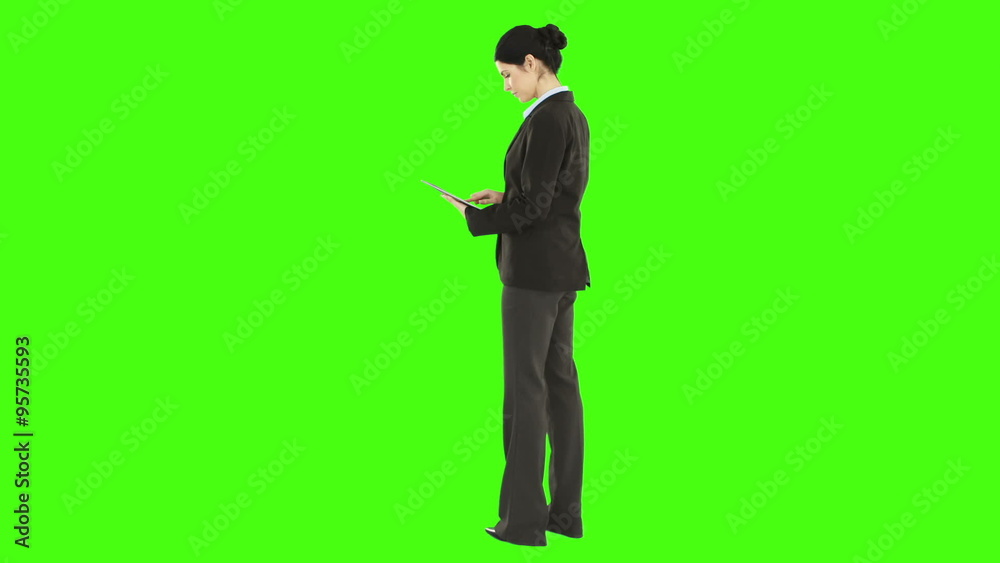 Business woman standing and using a tablet Business woman standing and using a tablet