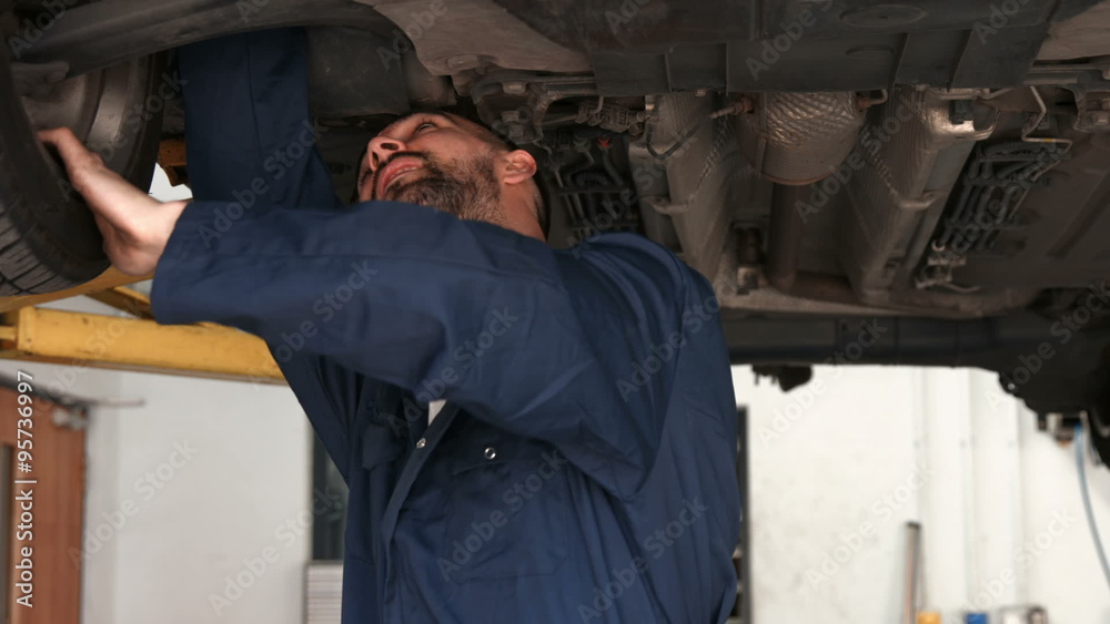 Mechanic overhauling a car Mechanic overhauling a car