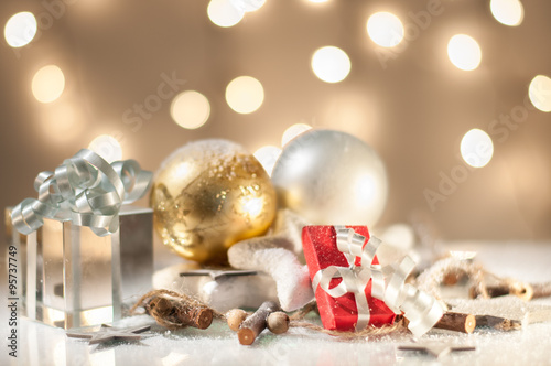 Christmas decoration with gift boxes, golden and white glass balls. Lights in background. Shallow depth of field.  © lidiaphotobook