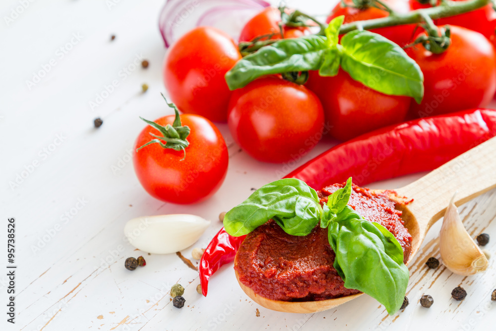 Tomato sauce and ingredients on white wood background Tomato sauce and ingredients on white wood background