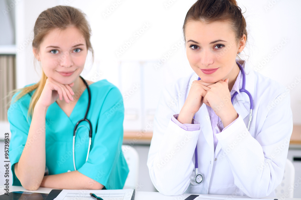 Female doctor and young surgeon intern in hospital Female doctor and young surgeon intern in hospital