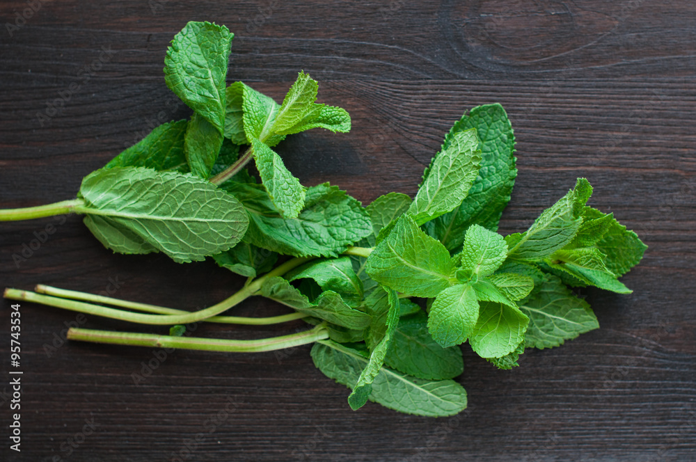 fresh mint leaves on the wooden background fresh mint leaves on the wooden background