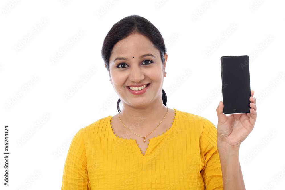 Young woman holding mobile phone against white Young woman holding mobile phone against white