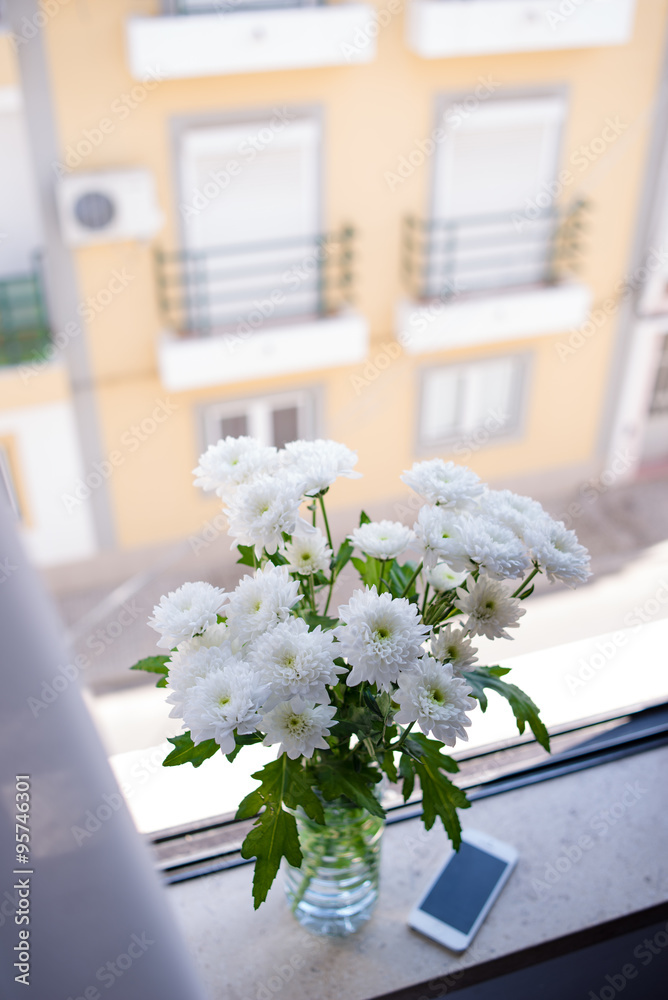fresh chrysanthemum in vase on the window sill
