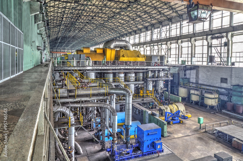 Machine room in thermal power plant with electric generators and turbines