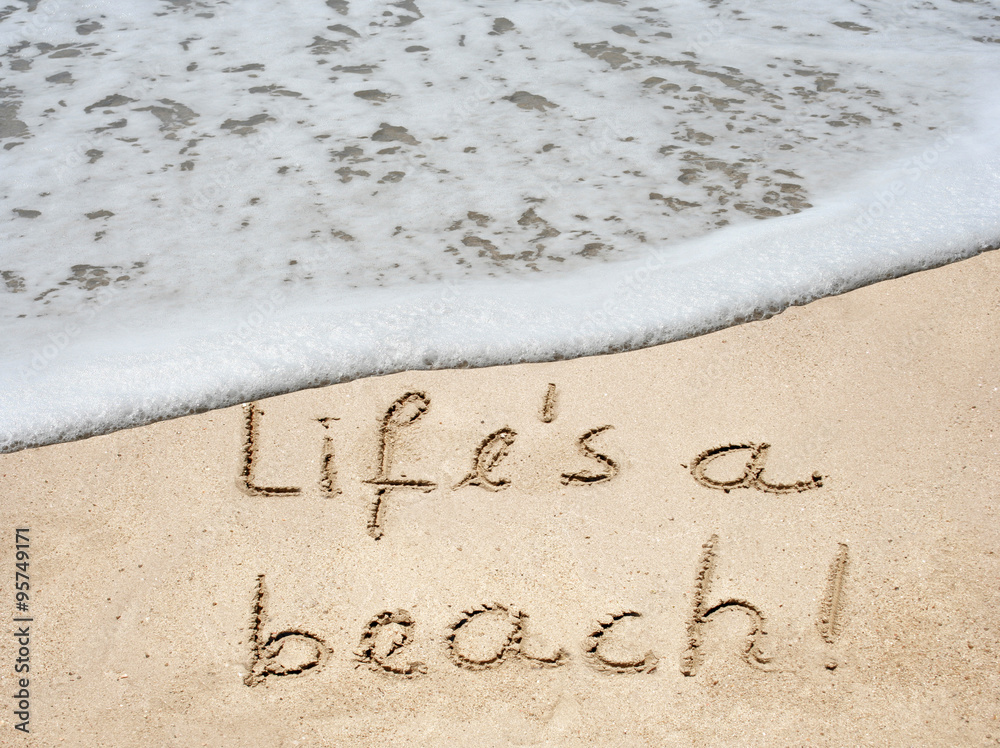 Fototapeta premium Conceptual life is a beach text in sand and water