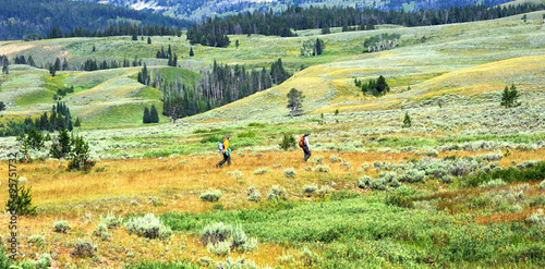Field work, for two park rangers in Yellowstone National Park, includes spraying and maintaining control of grass and weeds.