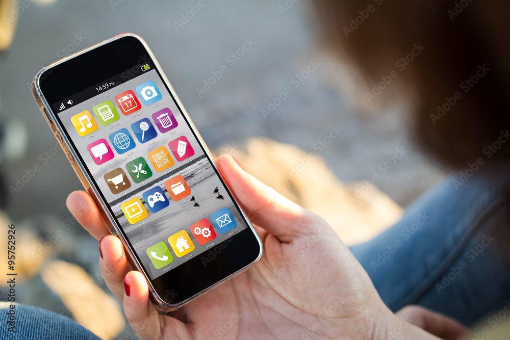 woman sitting in the street holding her smartphone woman sitting in the street holding her smartphone