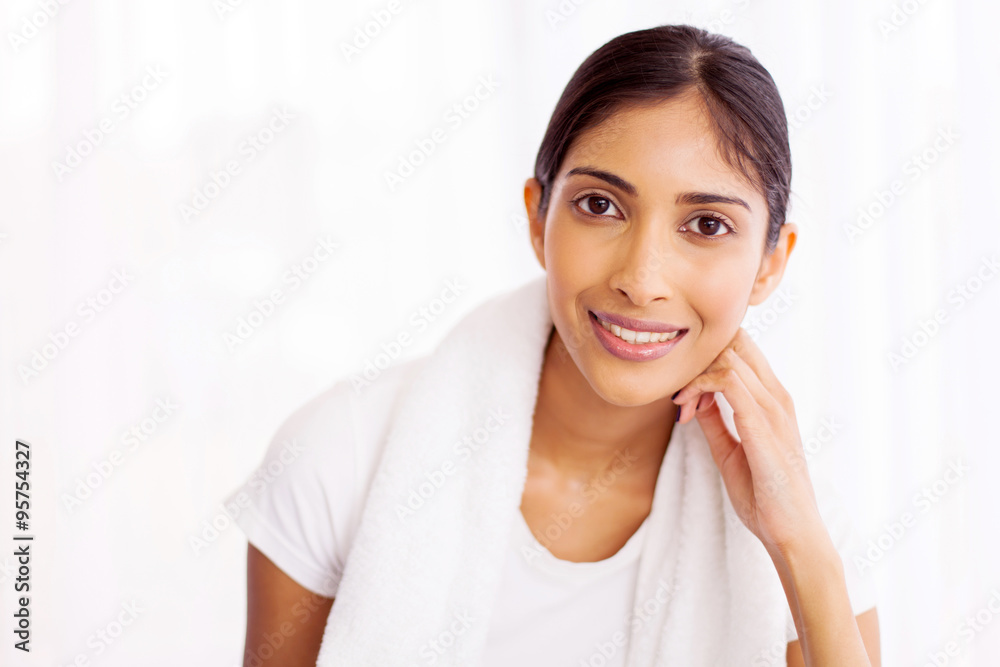 young indian woman with towel after workout