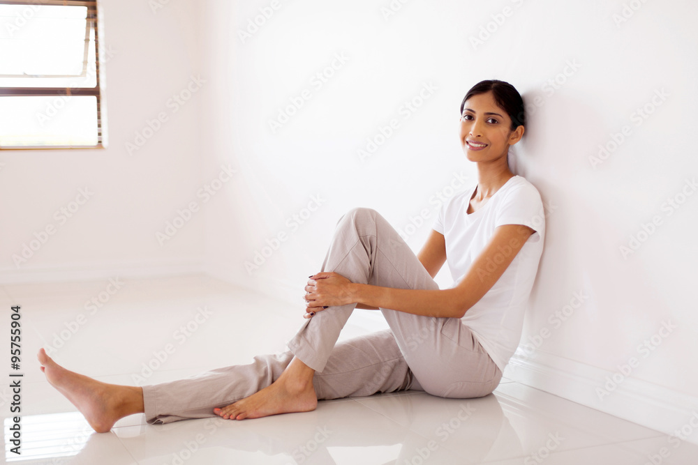 young indian woman sitting in empty house young indian woman sitting in empty house