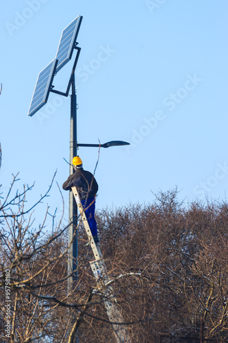 Male engineer at work place, solar collector