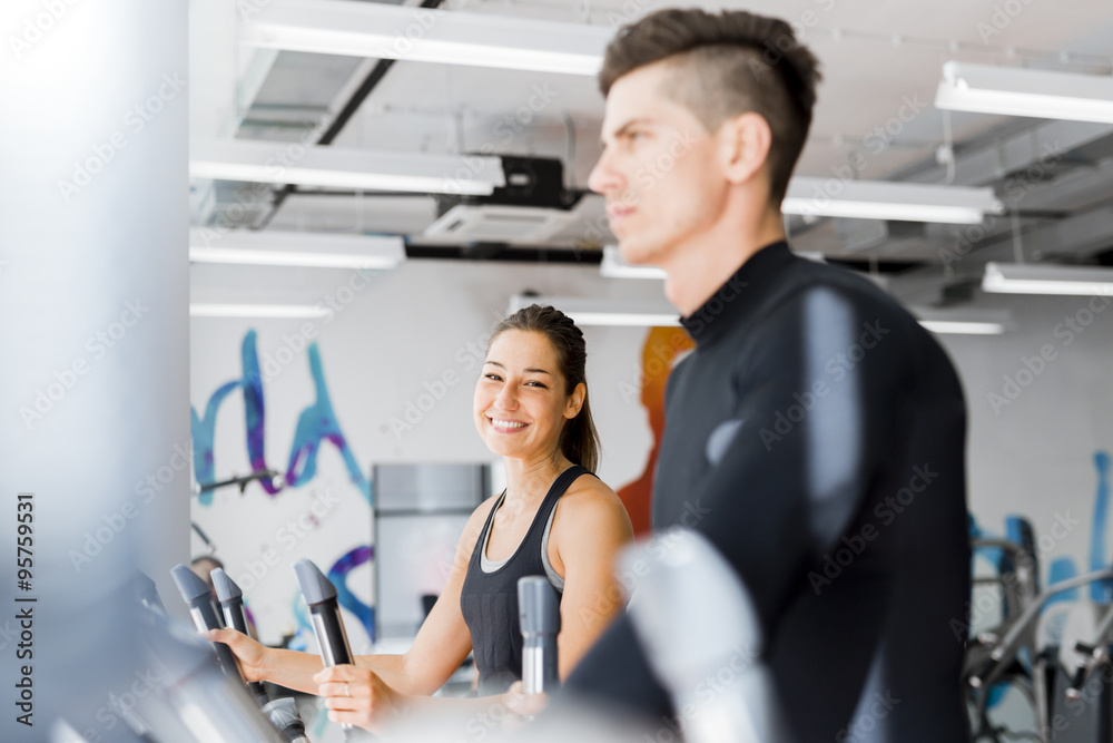 Young healthy group of people working out on a elliptic trainer
