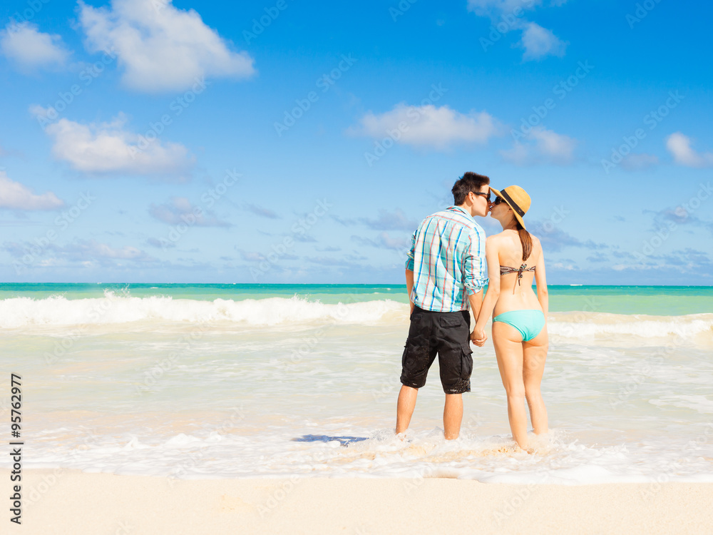 Couple kissing and enjoying the beach in beautiful Hawaii Couple kissing and enjoying the beach in beautiful Hawaii
