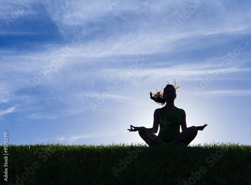 Woman meditating in a yoga pose © kieferpix