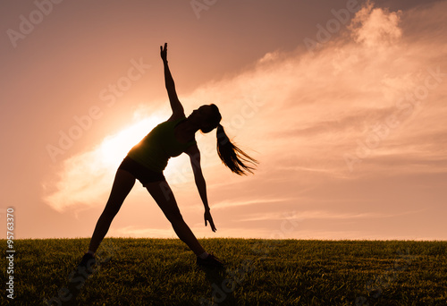 Woman doing stretching exercise outdoors © kieferpix