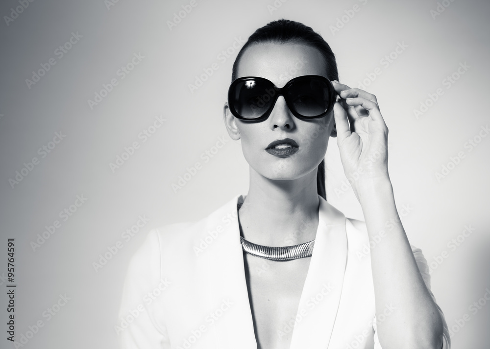 Female fashion portrait wearing sunglasses.
