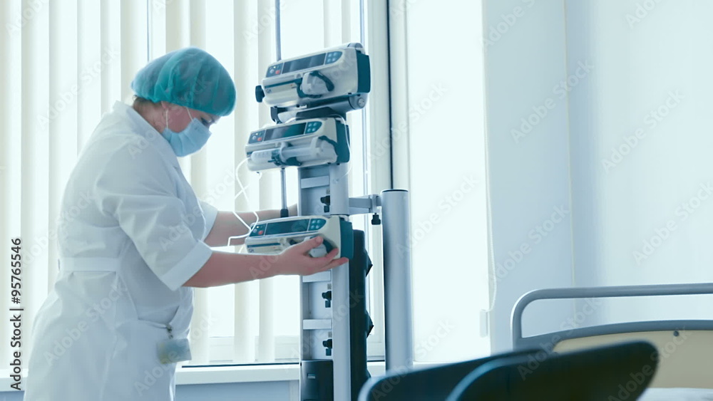 Nurse obstetrician is setting a medical equipment in delivery room before the birth of a child Nurse obstetrician is setting a medical equipment in delivery room before the birth of a child