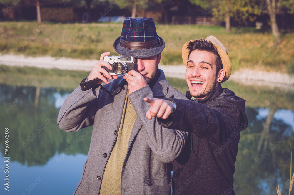 Fototapeta premium Two friends are taking a photograph outdoor 