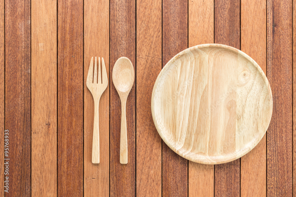 Empty wooden dish, fork and spoon on wooden table Empty wooden dish, fork and spoon on wooden table