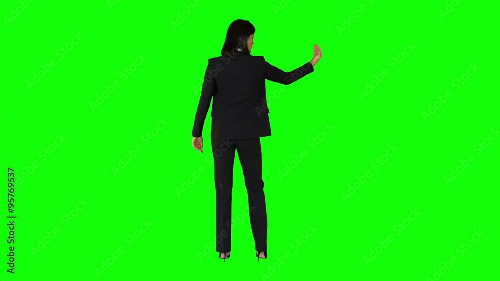 Businesswoman wearing something with her hands Businesswoman wearing something with her hands