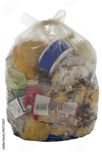 Transparent plastic bag containing household garbage, isolated on white.
