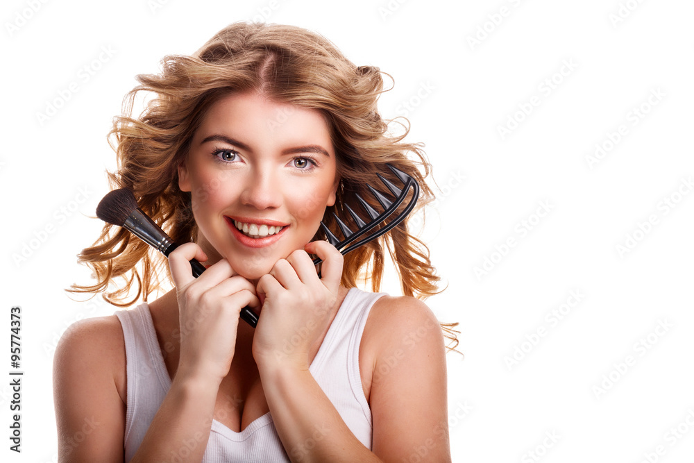 Girl with curly hair holding makeup brush and comb. Girl with curly hair holding makeup brush and comb.