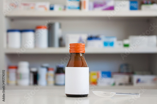 Blank white label of medicine bottle with blur shelves of drug i