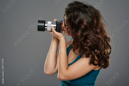 Woman with photo camera in a studio