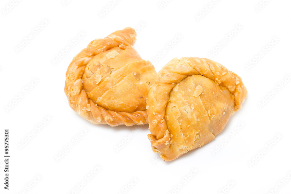 Two curry puffs isolated on white.